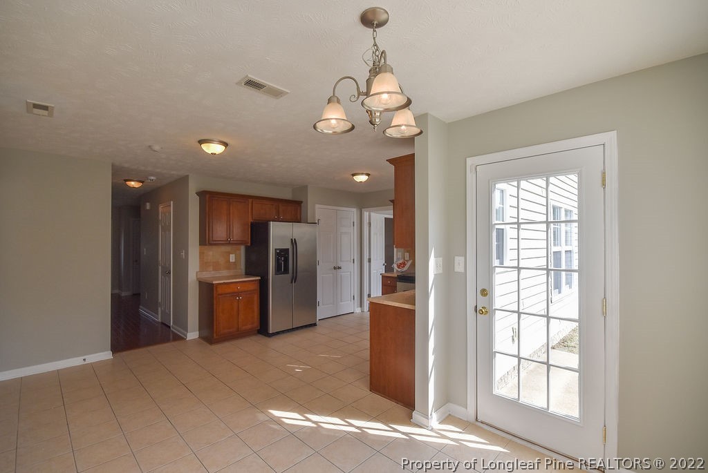 6700 Valley Falls Road Hope Mills, NC 28348 - Photo 16 of 48 a view of a kitchen with refrigerator and microwave