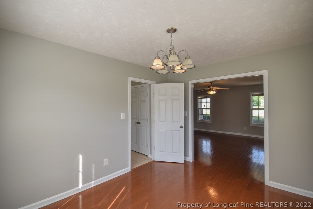 6700 Valley Falls Road Hope Mills, NC 28348 - Photo 20 of 48 a view of livingroom with chandelier and wooden floor