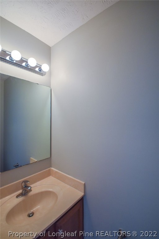 6700 Valley Falls Road Hope Mills, NC 28348 - Photo 22 of 48 a bathroom with a sink and a mirror