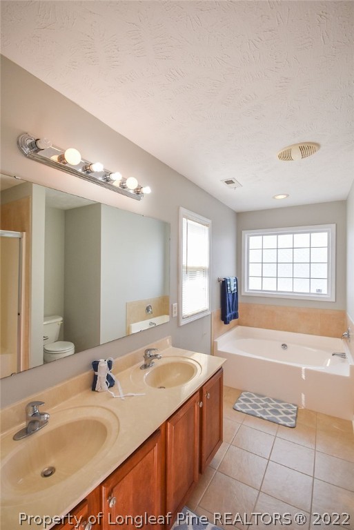 6700 Valley Falls Road Hope Mills, NC 28348 - Photo 30 of 48 a spacious bathroom with a tub double sink window and mirror