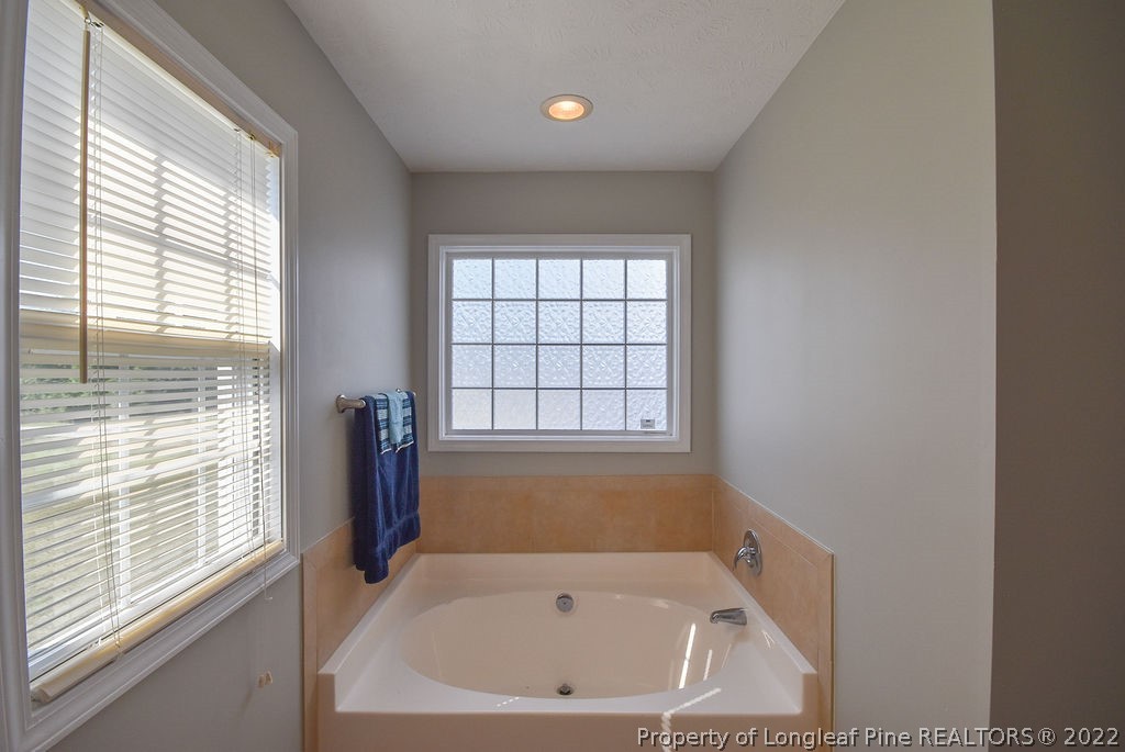 6700 Valley Falls Road Hope Mills, NC 28348 - Photo 32 of 48 a bathroom with a bathtub and window