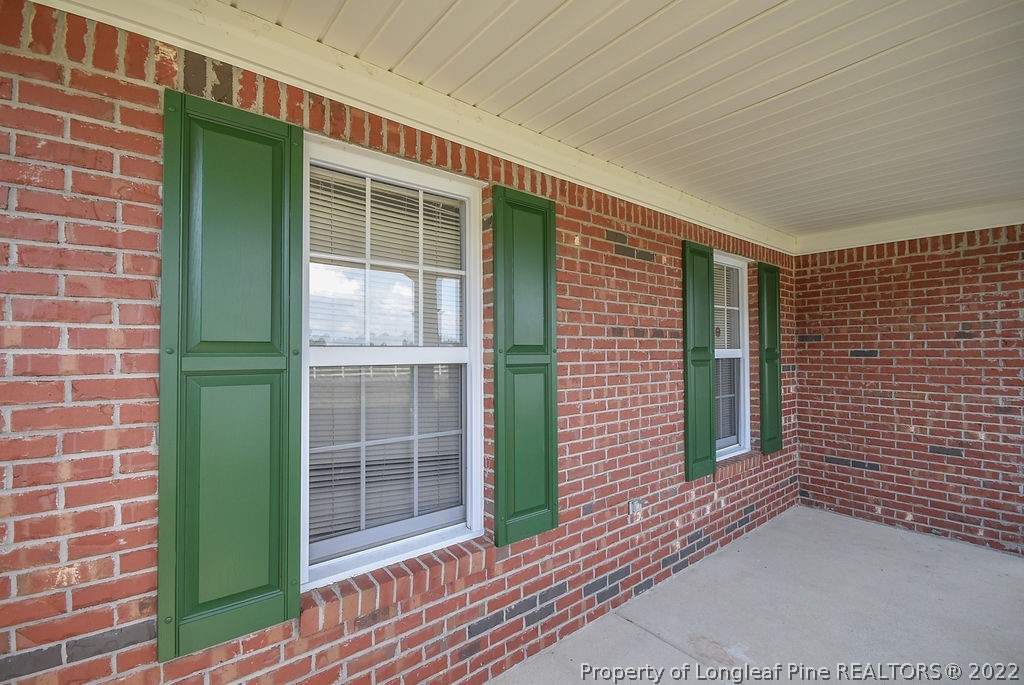 6700 Valley Falls Road Hope Mills, NC 28348 - Photo 4 of 48 a view of a brick house with a large window
