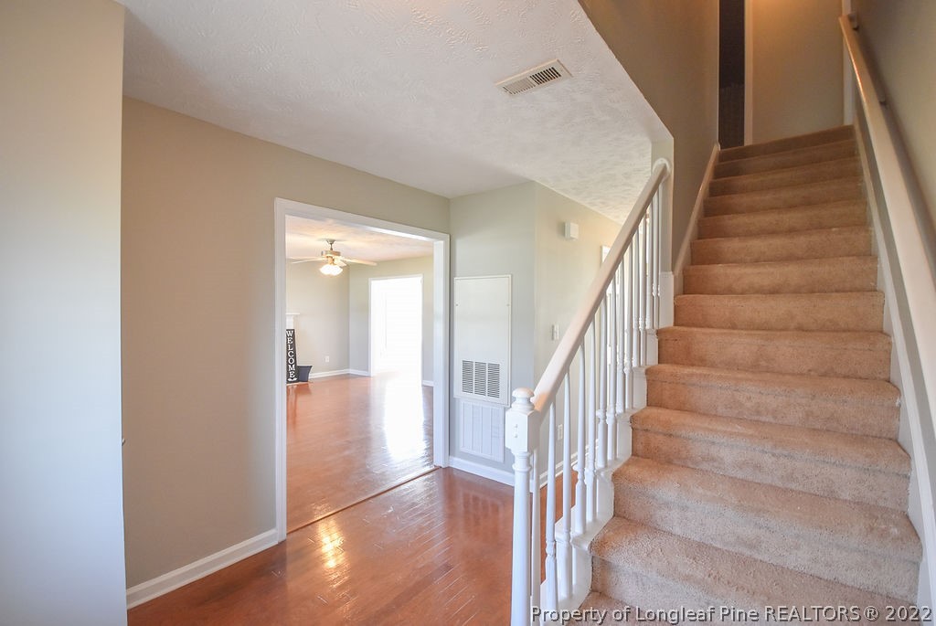 6700 Valley Falls Road Hope Mills, NC 28348 - Photo 6 of 48 a view of staircase with white walls and white walls