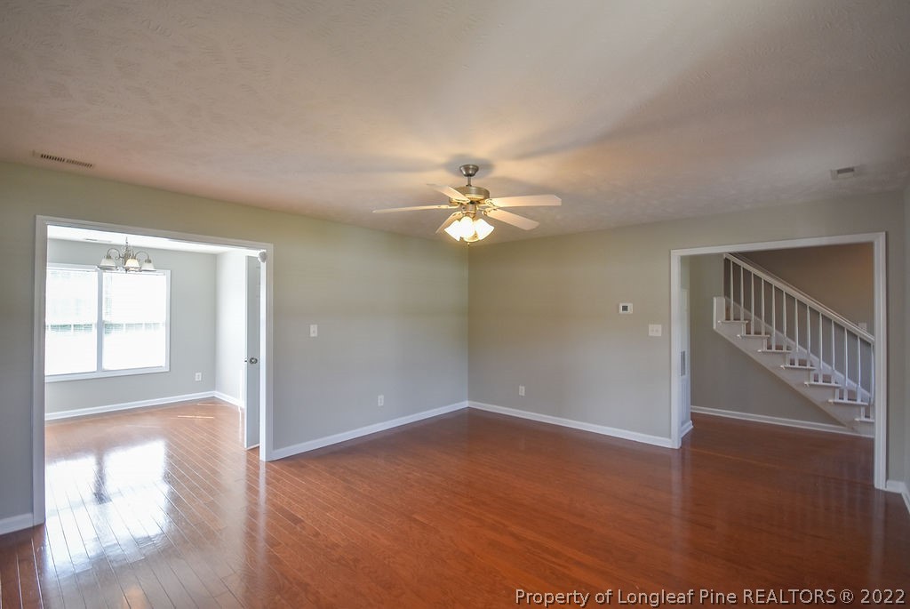 6700 Valley Falls Road Hope Mills, NC 28348 - Photo 8 of 48 a view of an empty room with wooden floor and a window