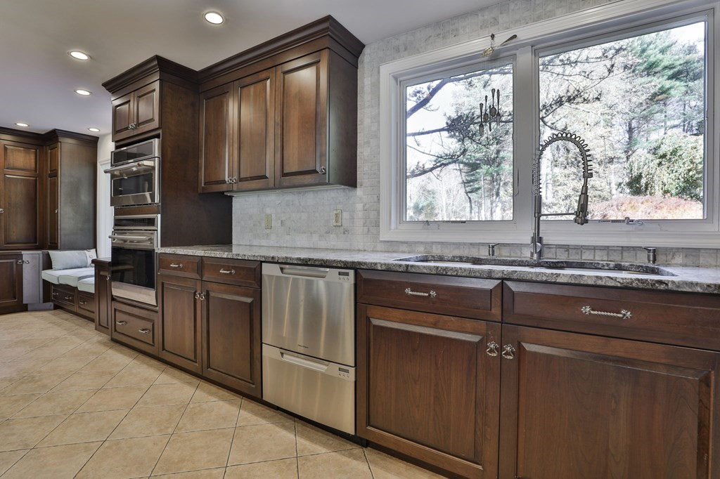 13 Haskell Lane Harvard, MA 01451 - Photo 11 of 39 a kitchen with granite countertop wooden cabinets a sink and a window