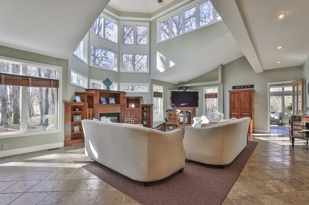 13 Haskell Lane Harvard, MA 01451 - Photo 17 of 39 a living room with furniture and a book shelf