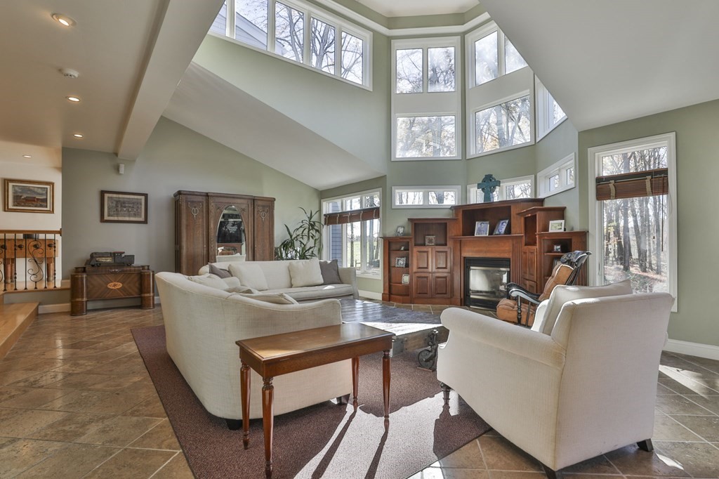 13 Haskell Lane Harvard, MA 01451 - Photo 18 of 39 a living room with fireplace furniture and a large window