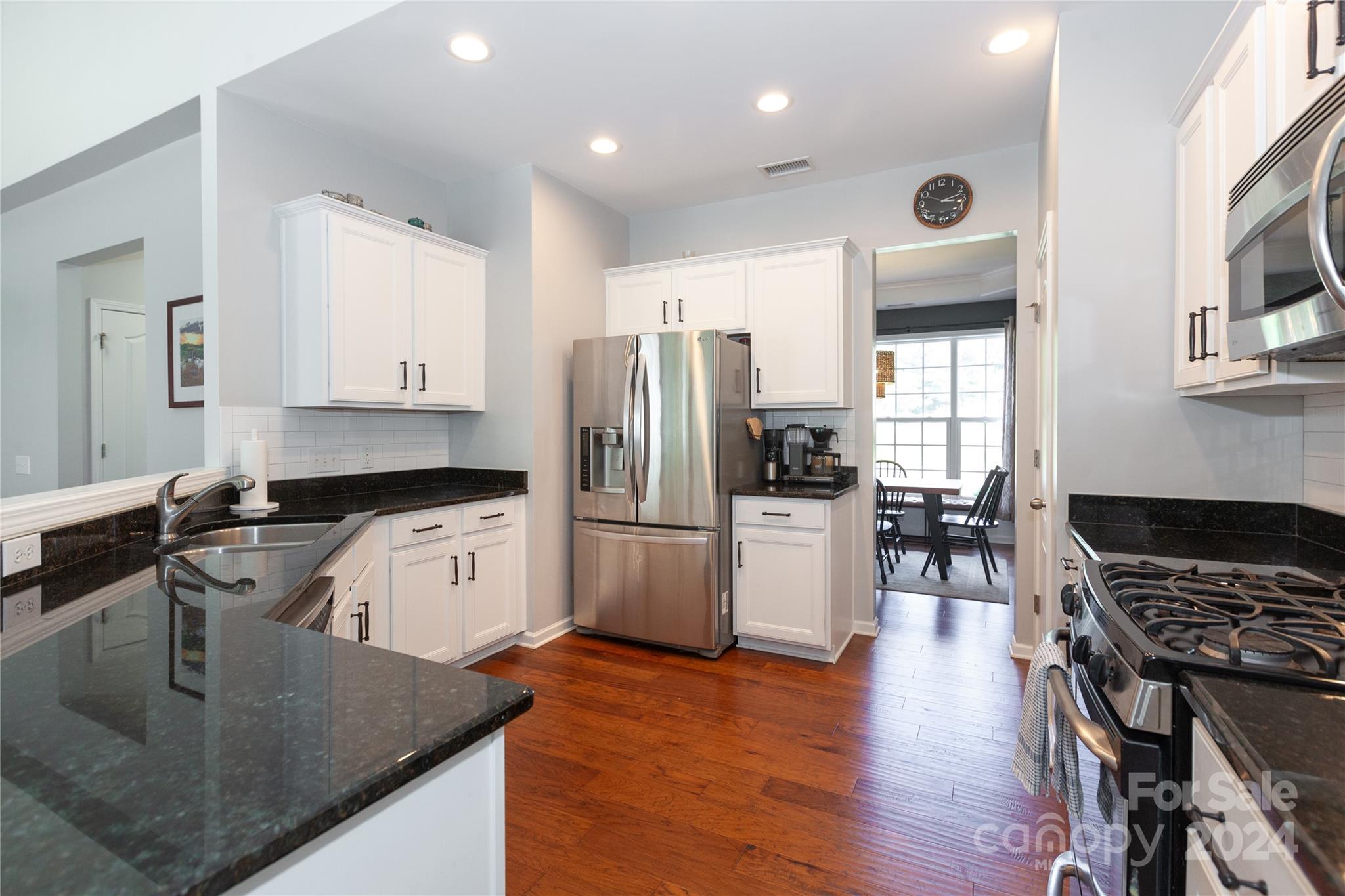 2304 Coltsgate Road Waxhaw, NC 28173 - Photo 11 of 29 a kitchen with stainless steel appliances granite countertop a sink stove and refrigerator