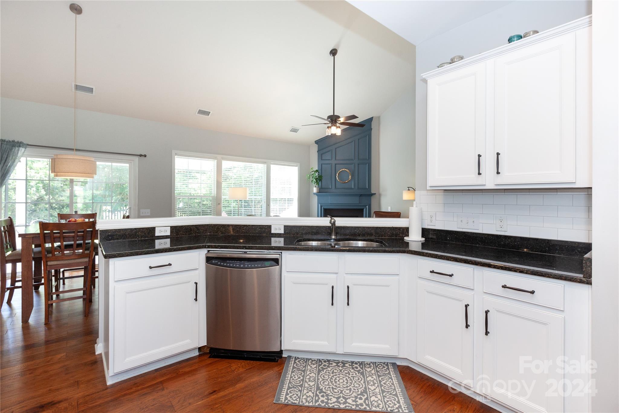 2304 Coltsgate Road Waxhaw, NC 28173 - Photo 12 of 29 a kitchen with stainless steel appliances granite countertop a stove and white cabinets