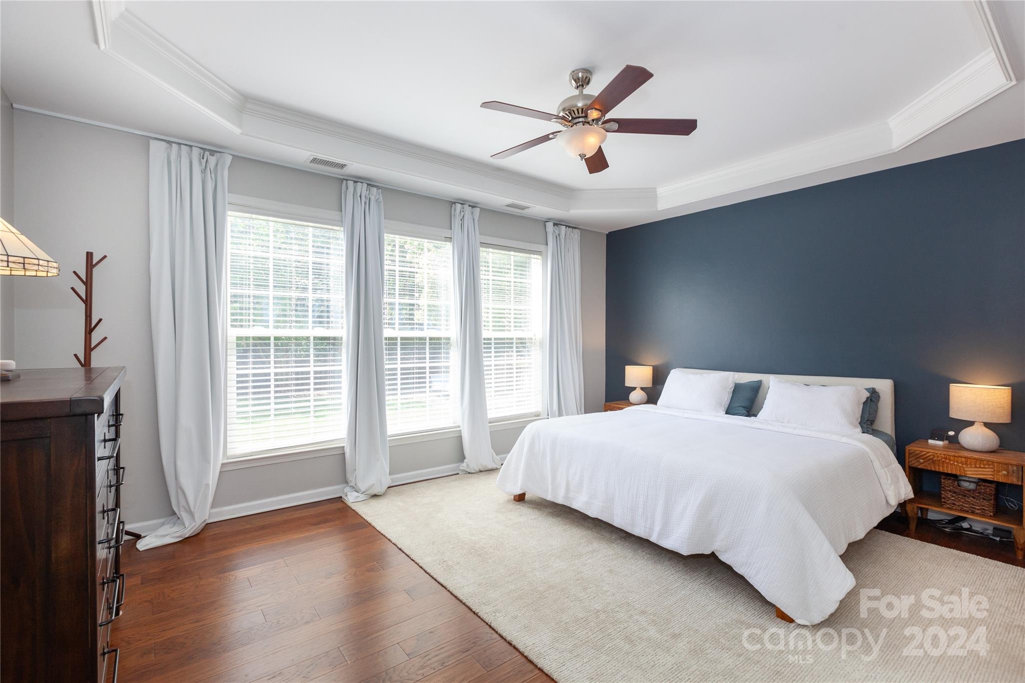 2304 Coltsgate Road Waxhaw, NC 28173 - Photo 14 of 29 a bedroom with a large bed and a chandelier