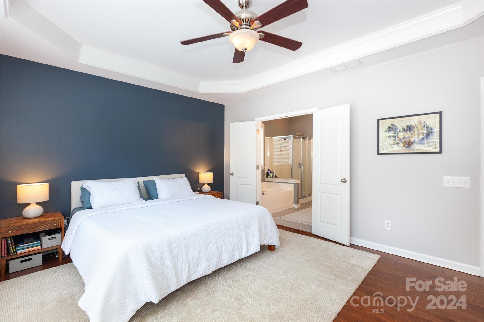 2304 Coltsgate Road Waxhaw, NC 28173 - Photo 15 of 29 a bedroom with a bed and a chandelier