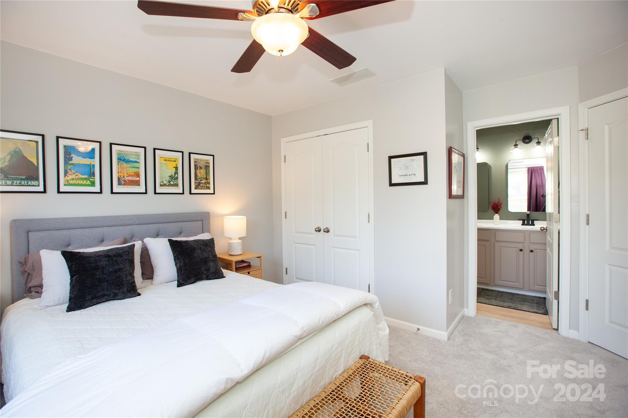 2304 Coltsgate Road Waxhaw, NC 28173 - Photo 23 of 29 a bedroom with a bed and a chandelier