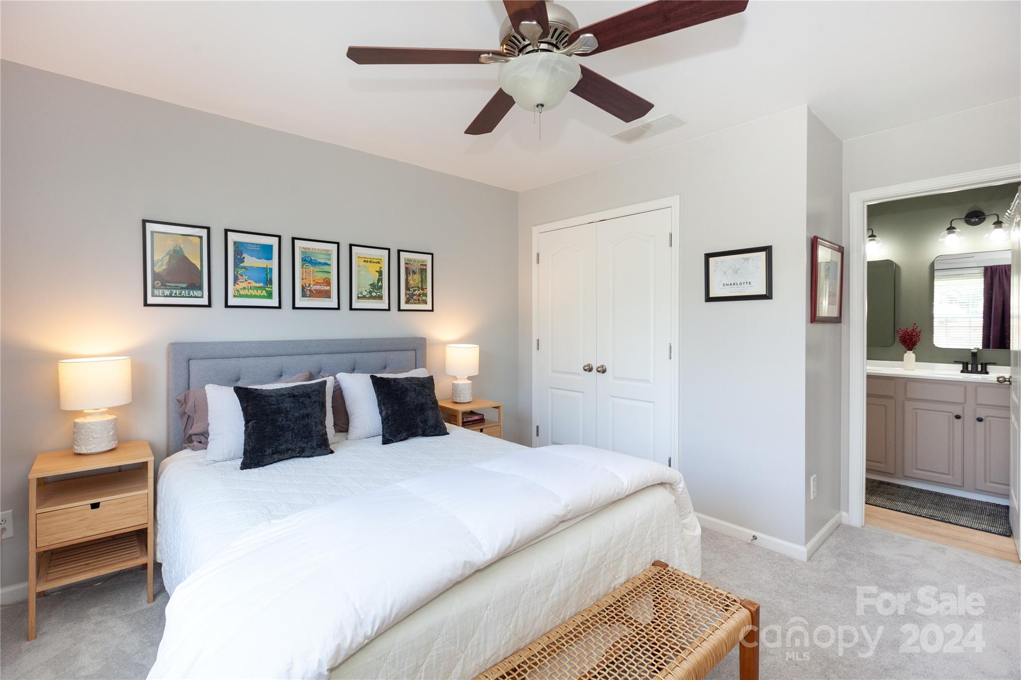 2304 Coltsgate Road Waxhaw, NC 28173 - Photo 24 of 29 a bedroom with a large bed and a chandelier