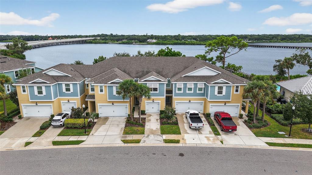2007 Palm Key Avenue Oldsmar, FL 34677 - Photo 4 of 54 an aerial view of multiple houses with a lake and a houses