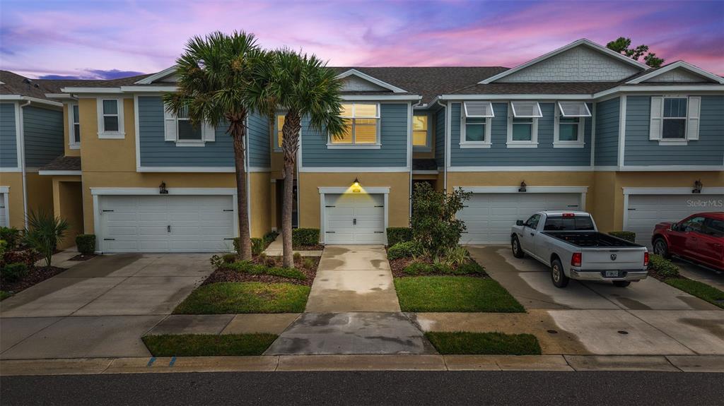 2007 Palm Key Avenue Oldsmar, FL 34677 - Photo 49 of 54 a front view of a house with a yard and garage