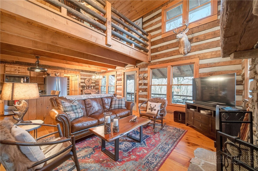 376 Yellow Bear Road Todd, NC 28684 - Photo 17 of 29 a living room with patio furniture and a flat screen tv