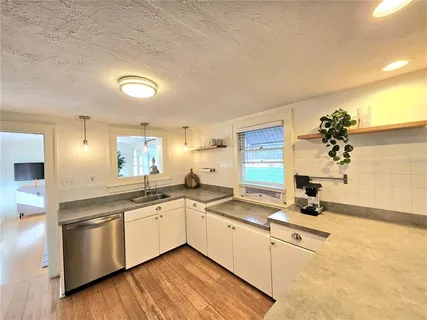 a kitchen with a sink cabinets and window