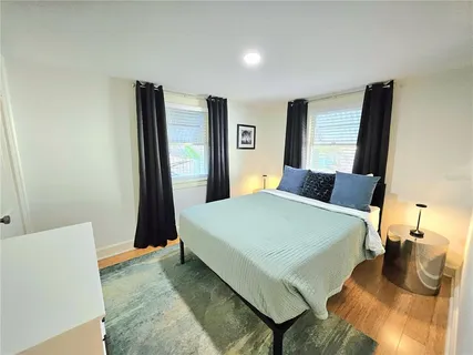 a bed sitting in a bedroom next to a window