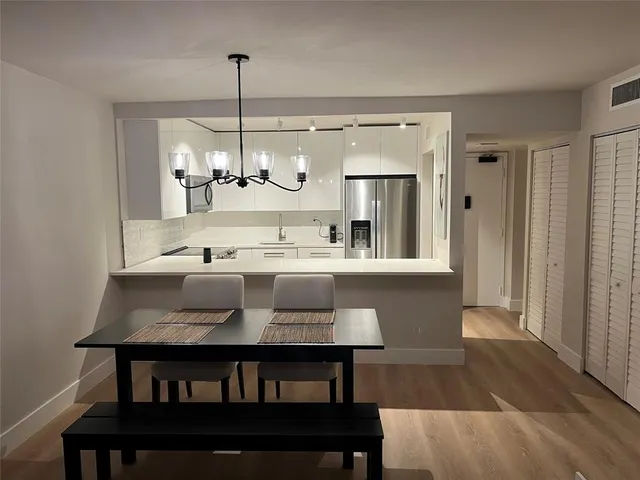 a kitchen with a table and chairs in it