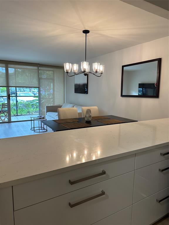 3821 Environ Boulevard, Unit 110 Lauderhill, FL 33319 - Photo 3 of 9 a view of a room with furniture and a chandelier