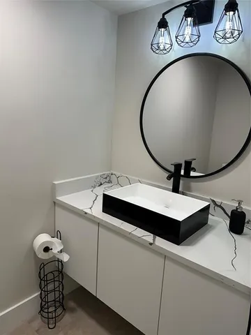 a bathroom with a sink and mirror