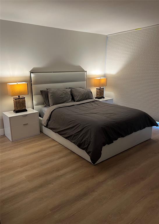 3821 Environ Boulevard, Unit 110 Lauderhill, FL 33319 - Photo 8 of 9 a bedroom with a bed and lamp