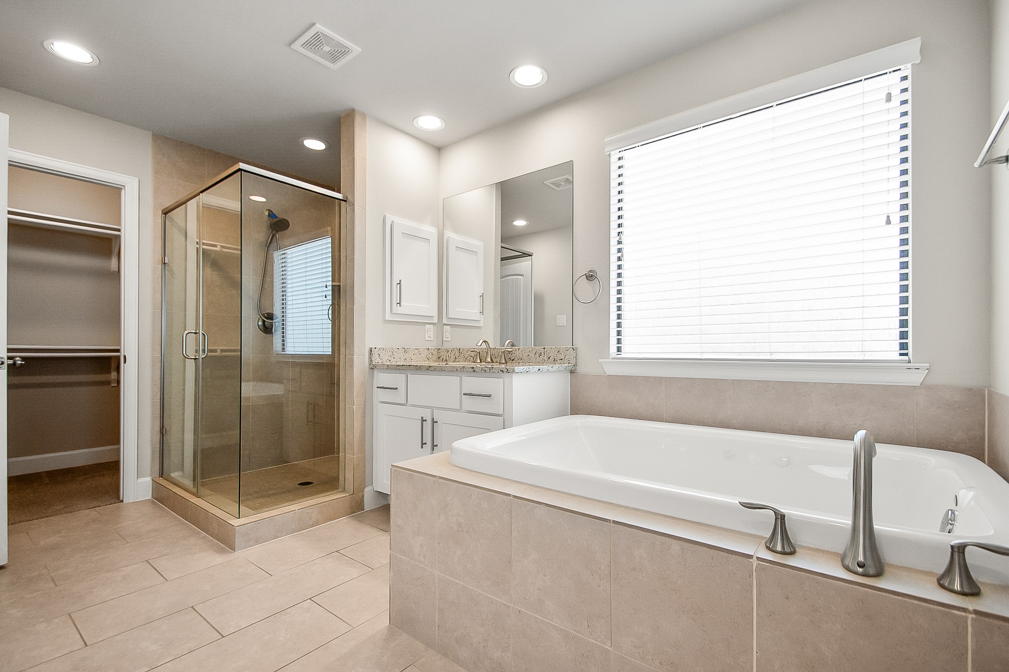 5328 Larkin Street Houston, TX 77007 - Photo 13 of 27 Primary bathroom featuring a spa-like layout with a separate soaking bathtub and a walk-in shower.