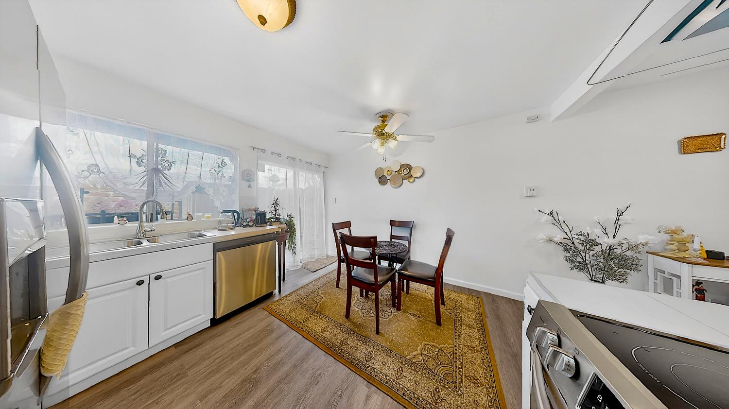617 West Granger Avenue, Unit 66 Modesto, CA 95350 - Photo 13 of 46 a view of a dining room with furniture a rug and wooden floor