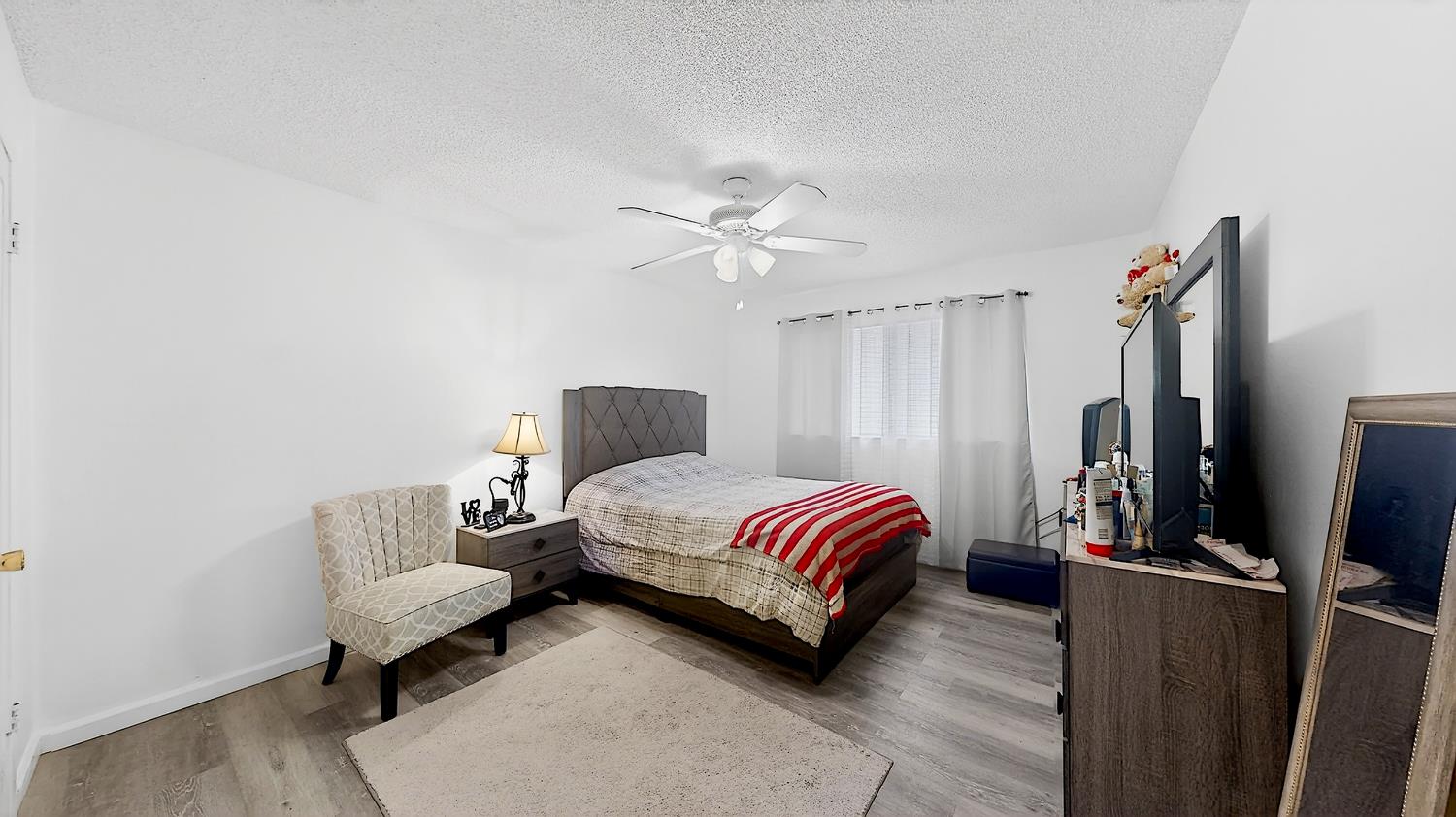 617 West Granger Avenue, Unit 66 Modesto, CA 95350 - Photo 20 of 46 a bedroom with a bed desk and a couch