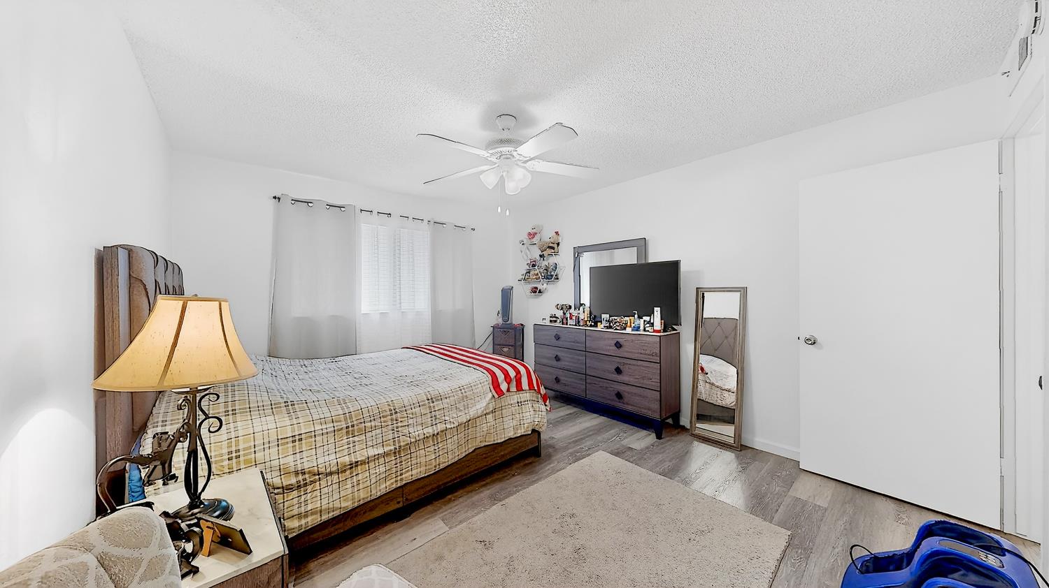 617 West Granger Avenue, Unit 66 Modesto, CA 95350 - Photo 21 of 46 a bedroom with a bed a flat screen tv and dresser