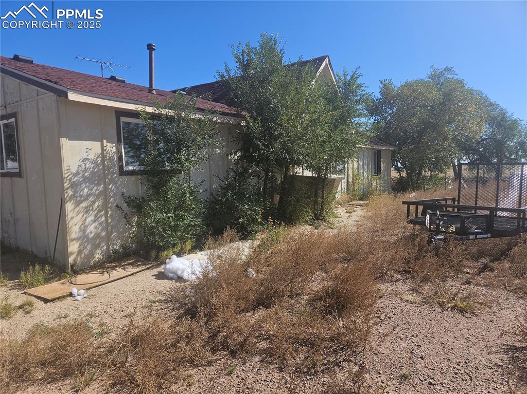 10450 Squirrel Creek Road Colorado Springs, CO 80928 - Photo 2 of 2 a backyard of a house with yard and outdoor seating