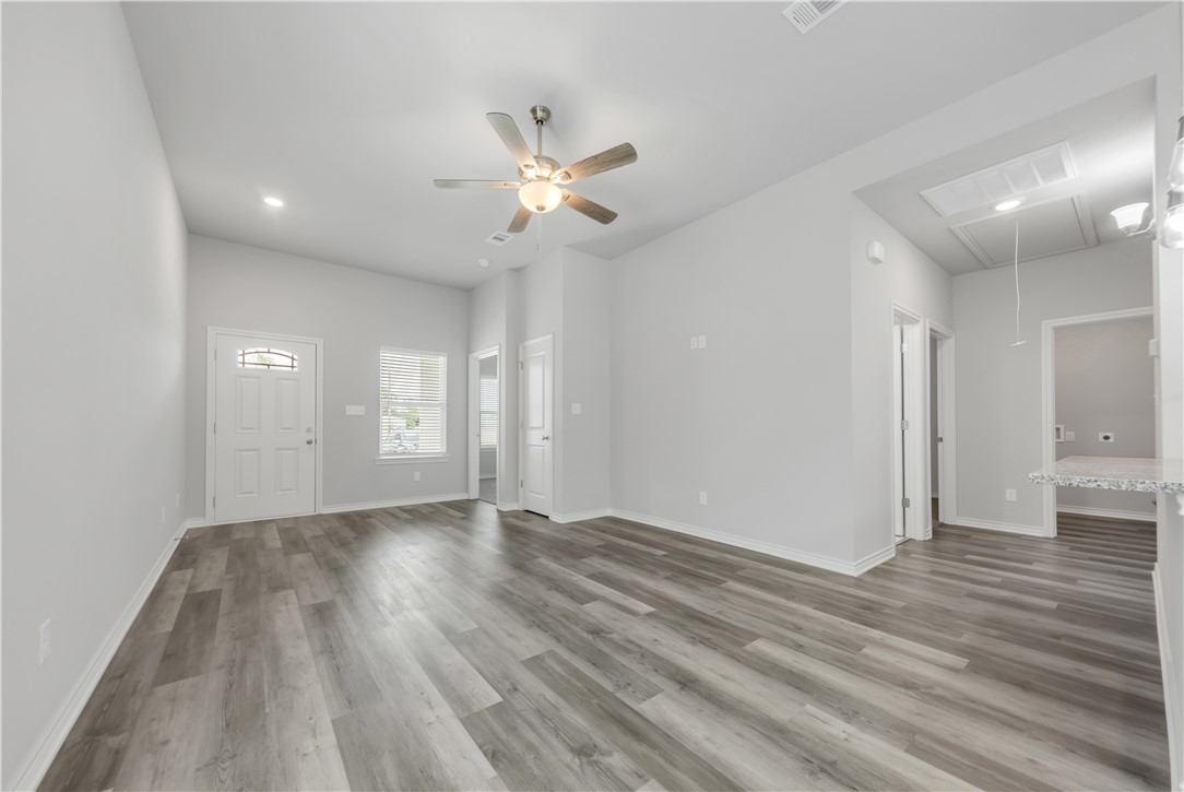 1805 Pin Oak Street Bryan, TX 77803 - Photo 7 of 20 Unfurnished living room featuring attic access, a ceiling fan, light wood-style flooring, and recessed lighting