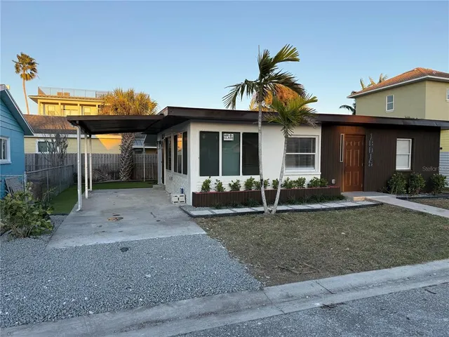 a view of a house with backyard and porch