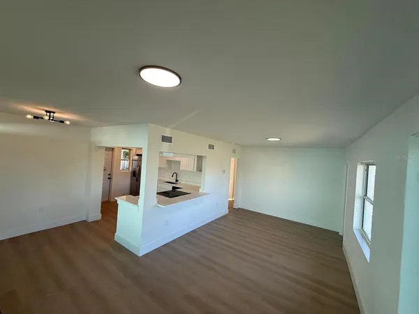 a view of a kitchen with wooden floor