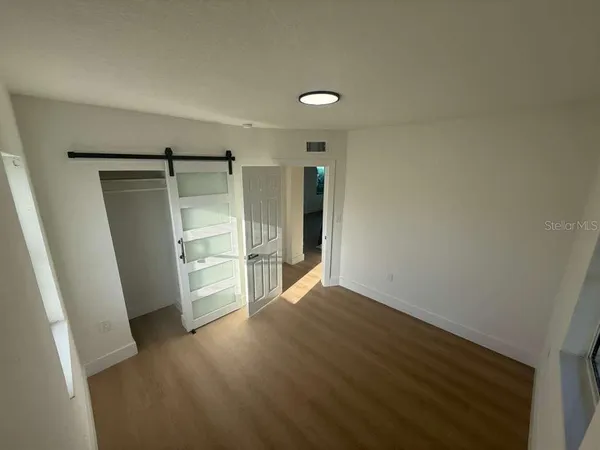 an empty room with wooden floor