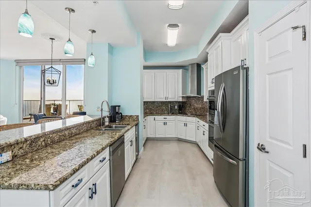 a kitchen with white cabinets and appliances