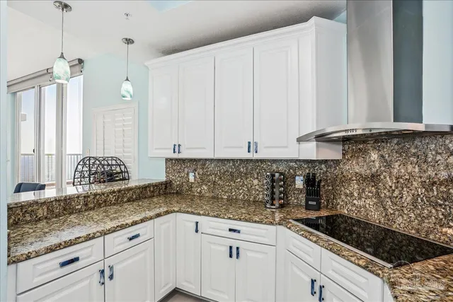 a kitchen with stainless steel appliances granite countertop a stove and a refrigerator