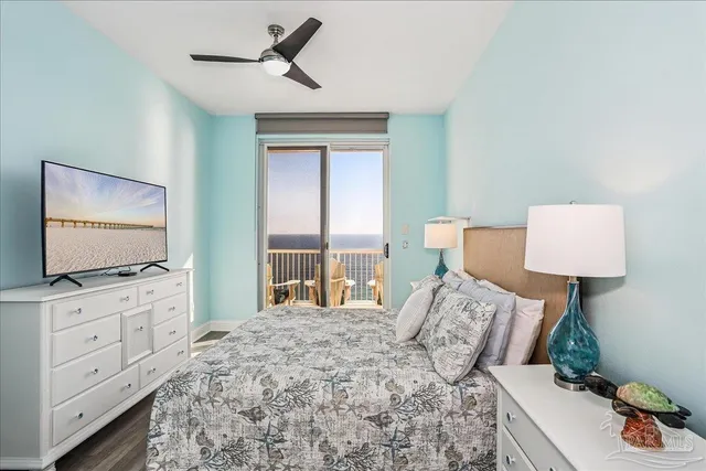 a bedroom with a bed and a lamp on the dresser