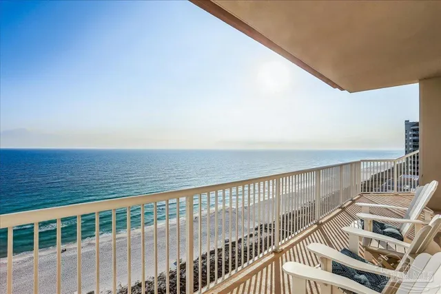 a view of a balcony with floor to ceiling window stairs and wooden floor