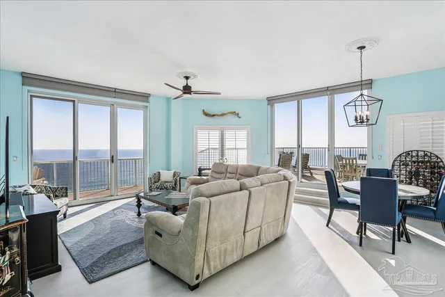 a living room with furniture fireplace and a large window