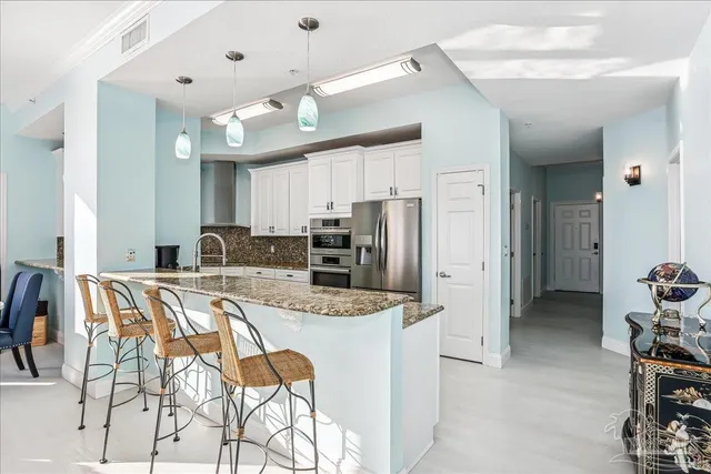 a kitchen with a stove a sink and a refrigerator