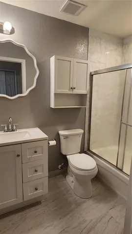a view of a hallway to a livingroom and a kitchen with furniture