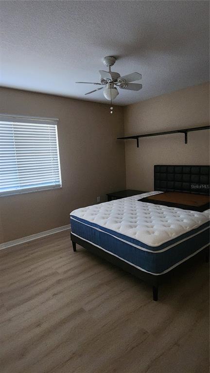 Undisclosed Address North Port, FL 34287 - Photo 16 of 27 a bedroom with a bed and wooden floor