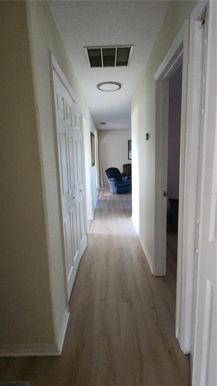 Undisclosed Address North Port, FL 34287 - Photo 18 of 27 a view of a hallway to a livingroom and a kitchen with furniture
