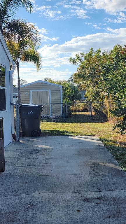 Undisclosed Address North Port, FL 34287 - Photo 2 of 27 a view of a swimming pool with an outdoor seating and a yard