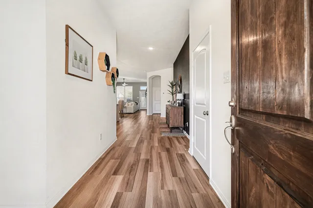 a view of a hallway view with wooden floor and staircase