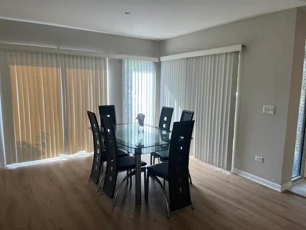 a view of a dining room with furniture and window