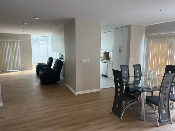 a view of a dining room with furniture and wooden floor