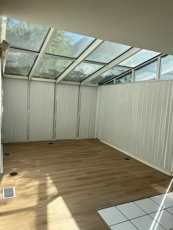 a view of a room with wooden floor