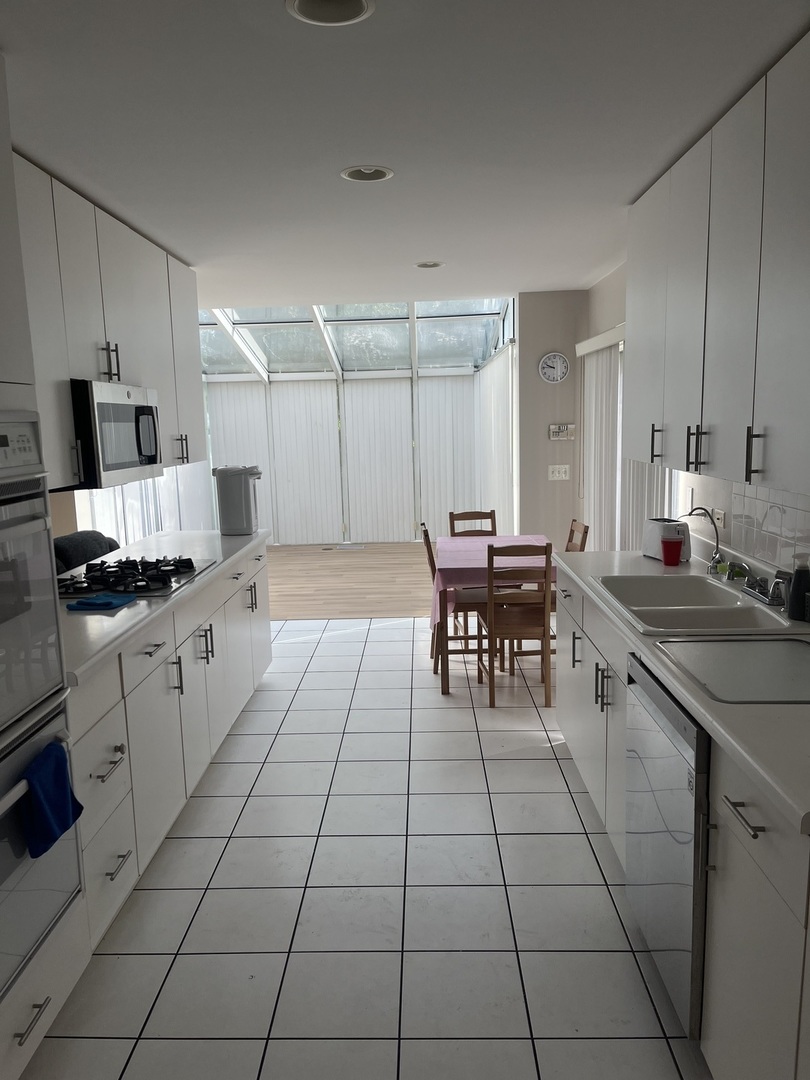 501 Kelburn Road Deerfield, IL 60015 - Photo 7 of 15 a kitchen with a sink and cabinets